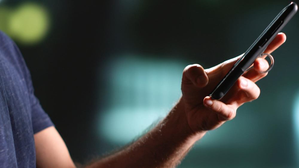 Homem usando celular para navegar na internet